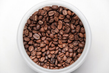 Medium roasted coffee beans inside a glass jar Arabica coffee beans