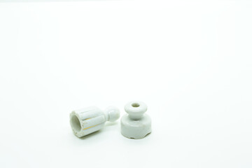 Two small antique insulators on white