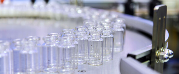 Clear glass bottles, vaccine vial transfer on automated conveyor systems automation for...