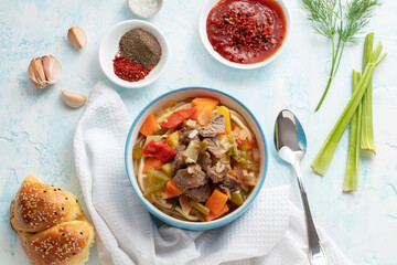 Uzbek food with noodles, vegetables and spices Lagman. Uyghur-style lagman with undercooked vegetables. Uzbek and Central Asia cuisine concept. Flatlay view