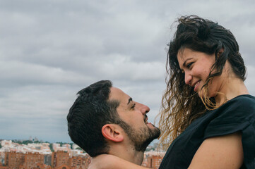 Young couple in love kissing and laughing in a park