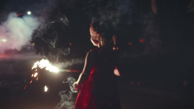 Neighborhood Fireworks and Cute Little Girl Dancing with Sparkler