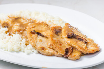 poultry meat with mushroom sauce and rice
