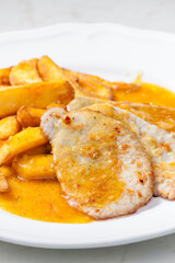 poultry meat on garlic with American potatoes and sauce