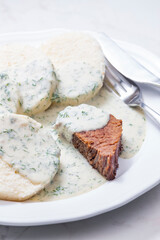 beef meat with dill sauce and dumplings
