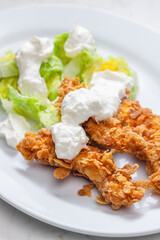fried chicken in cornflakes with lettuce and garlic dip
