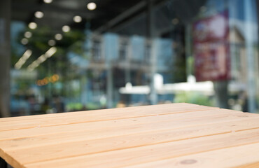 Fototapeta na wymiar Empty wooden table top with lights bokeh on blur restaurant background.
