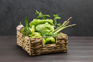 Asparagus, Savoy cabbage, lime and pepper in rattan basket