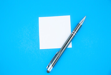 Blank white To Do List Sticker with pen. Searching information on the Internet..Close up of reminder note paper on the blue background. Copy space. Minimalism, original and creative.