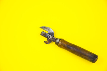 Old wooden corkscrew..Bottle opener close up on yellow background.