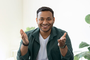 Head shot portrait Indian freelancer businessman looking at camera and talking, young leader...