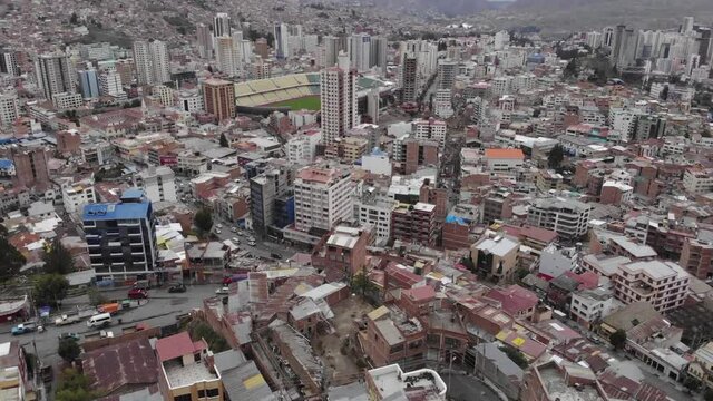 Aerial from crowded hillside toward La Paz Olympic Stadium, Bolivia