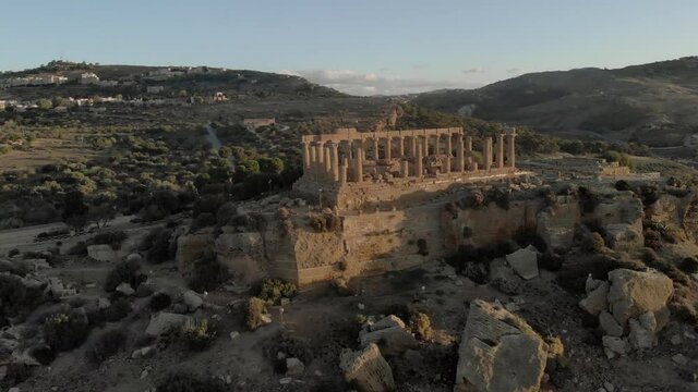 Clifftop ruin of Roman Giunone Temple of Juno in golden dawn aerial