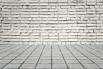 Empty room with bricks wall and tiled floor.