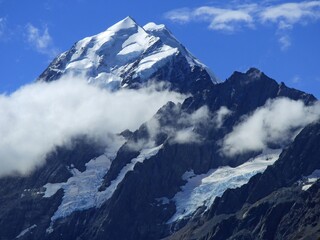 the snow-capped summit of mount cook on a sunny summer day as seen from the hooker valley track near mount cook village, on the south island of new zealand
