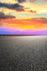 Asphalt highway and mountain landscape at sunset,road pavement background.