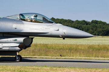 Modern Air Force fighter jet plane taxiing before take off from a military air base