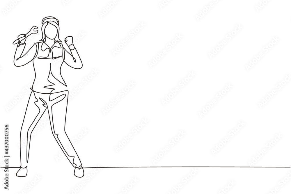 Wall mural Single one line drawing female mechanic stands up with celebrate gesture and holding wrench to perform maintenance vehicle engine. Success job. Continuous line draw design graphic vector illustration