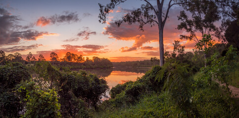 Beautiful Panoramic Riverside Sunset with Cloud Reflections