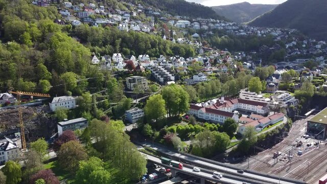 Expensive neighbourhood Kalfaret and Fjellsiden in Bergen Norway - Passing road E39 and Bergensbanen railway watching Floyfjellet - Aerial