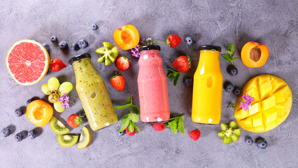 fruit smoothie in bottle and fresh fruits