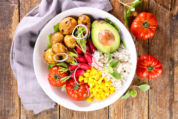 buddha bowl- salad with potato, avocado, tomato, radish and rice