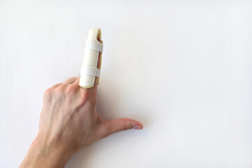 medical splint on a broken finger, on a white background. Medical assistance in case of injury. Copy space