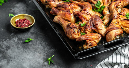 Baked chicken wings and legs on baking tray, banner, menu recipe place for text, top view