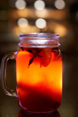 Christmas drink red non-alcoholic mulled wine with a straw on the background of the cafe interior, order for one