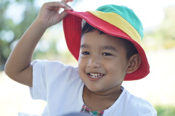 Cute Asian child little Thai boy 2 year old smile make a happy face concept. 