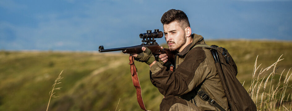 Shooter sighting in the target. The man is on the hunt. Hunt hunting rifle. Hunter man. Hunting period. Male with a gun. Close up. Hunter with hunting gun and hunting form to hunt. Hunter is aiming