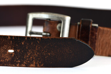 Old leather belt isolated on white background.