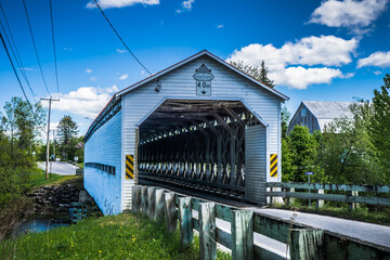 Obraz premium Anse St Jean covered bridge is spanning over the Matapedia river near Amqui in Quebec, Canada