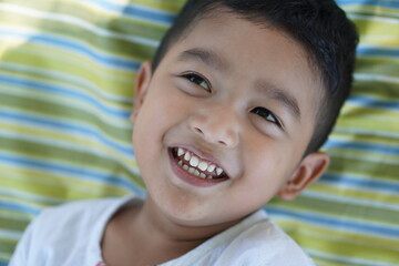 Cute Asian child little Thai boy 2 year old smile make a happy face concept. 