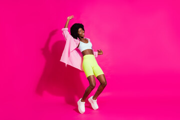 Photo of pretty adorable dark skin woman dressed crop top smiling dancing isolated pink color background