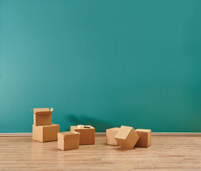 Cardboard box moving style with home object in the green room.