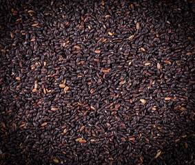 The raw black rice as background.. Selective focus
