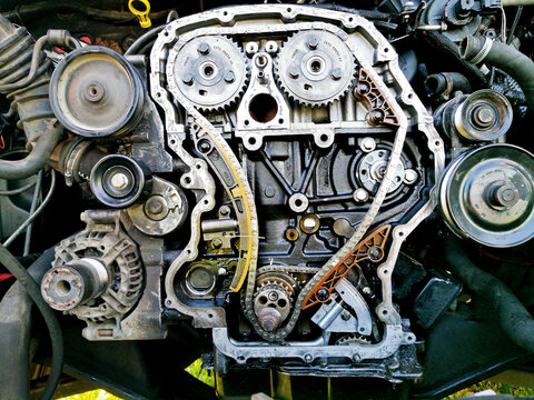 Disassembled Car Engine During Repair. A Close-up Of An Exploded View Of The Engine Chain, Gears And Tensioners During Repair And Recovery From Failure. Car Service.