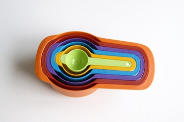 A set of measuring spoons made of colored plastic.