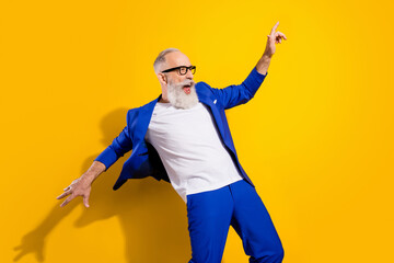 Photo of crazy happy cheerful old man look empty space wind fly blazer wear glasses isolated on...
