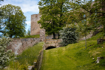 Gothic medieval castle Velhartice in sunny day, tower and stone arch bridge, fortress masonry wall, old stronghold, Velhartice, National Park Sumava, South Bohemia, Czech Republic
