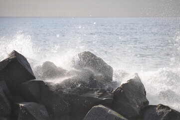 Splash water and stones at coastline of Pacific ocean, California