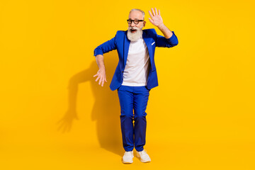Fototapeta na wymiar Full size photo of funny grey beard aged man dance wear spectacles blue jacket isolated on yellow background