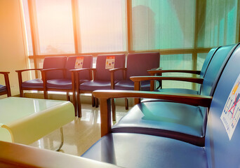 Social distancing. Empty dark blue chair with gap for social distance to prevent coronavirus (COVID-19) at waiting room in office for waiting queue. Public chair for social distancing in new normal.