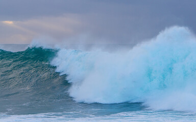 Stormy sky and breaking waves in the sea.