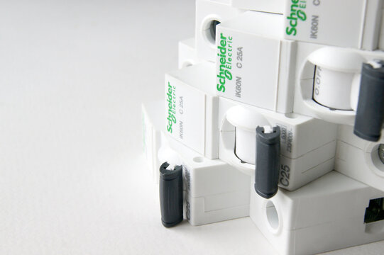 Schneider electric circuit breakers on white background.
