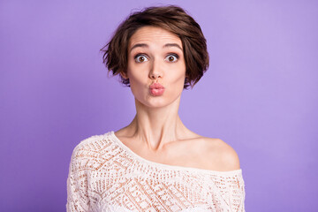 Photo of funny adorable young woman wear knitted shirt sending you kiss isolated violet color background
