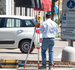 topographic survey in an urban area carried out by an engineer with theodolite or total positioning...