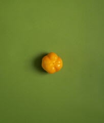 yellow pepper on a green background, fresh vegetable
