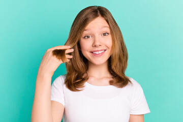 Photo portrait girl showing silky hair wearing t-shirt smiling isolated vibrant teal color background